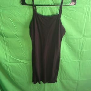 Black form fitting dress with bottom ruffle.